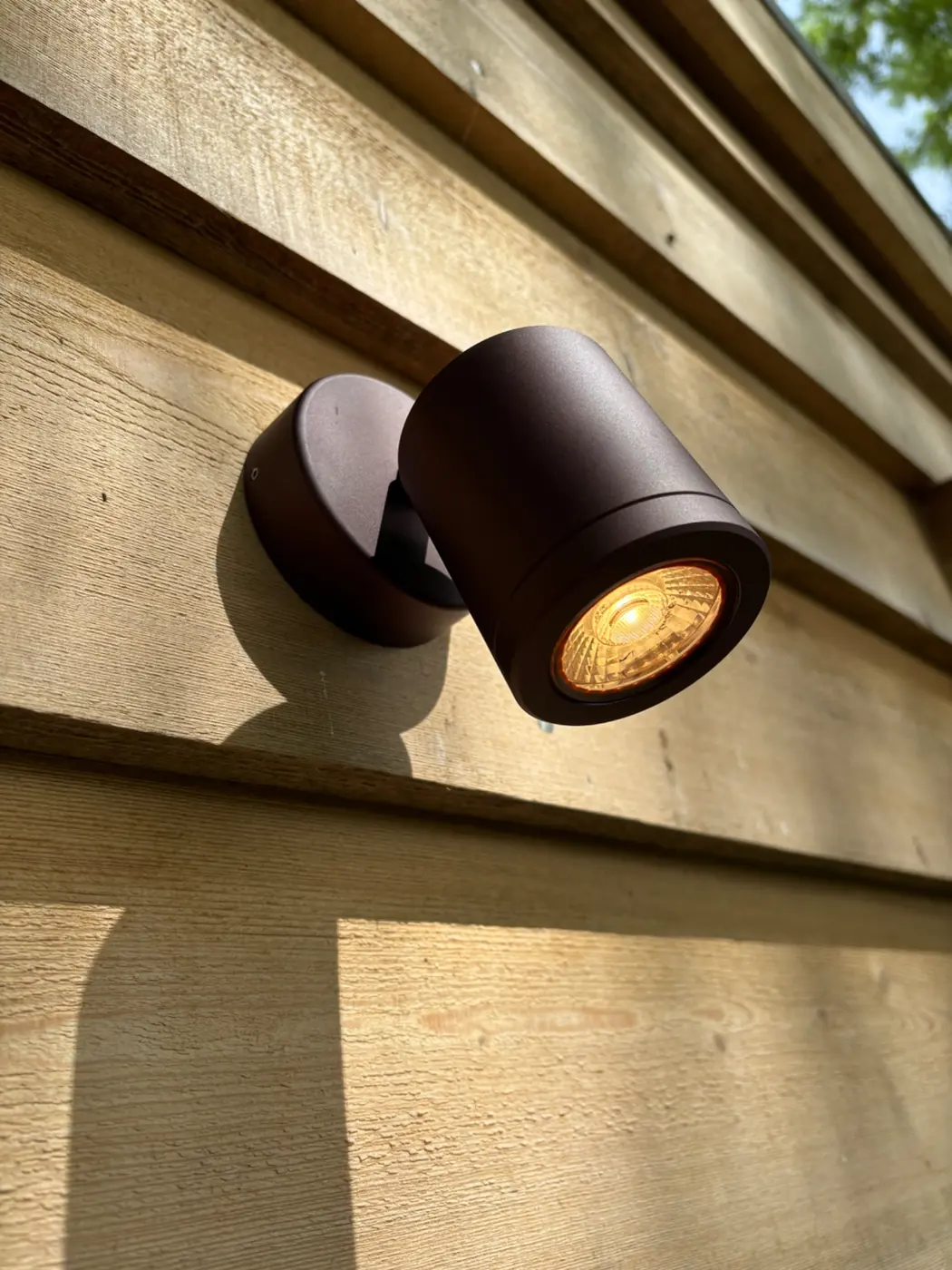 Exterior wall light installed on timber cladding
