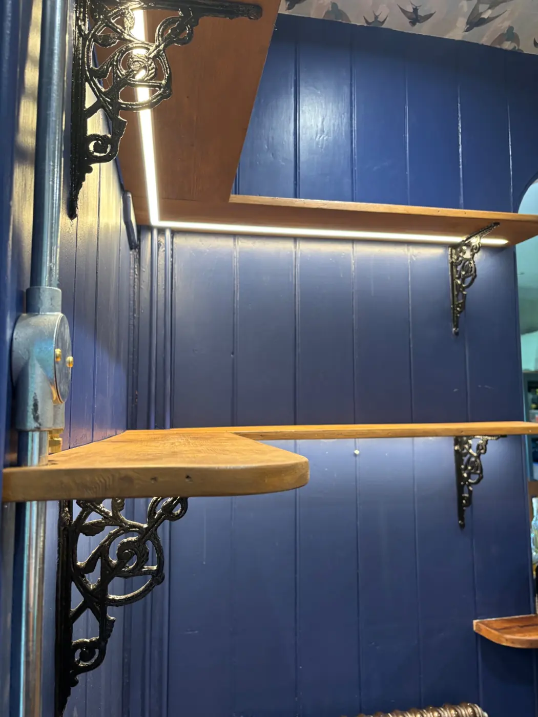 LED tape lighting following the shape of bespoke corner shelving
