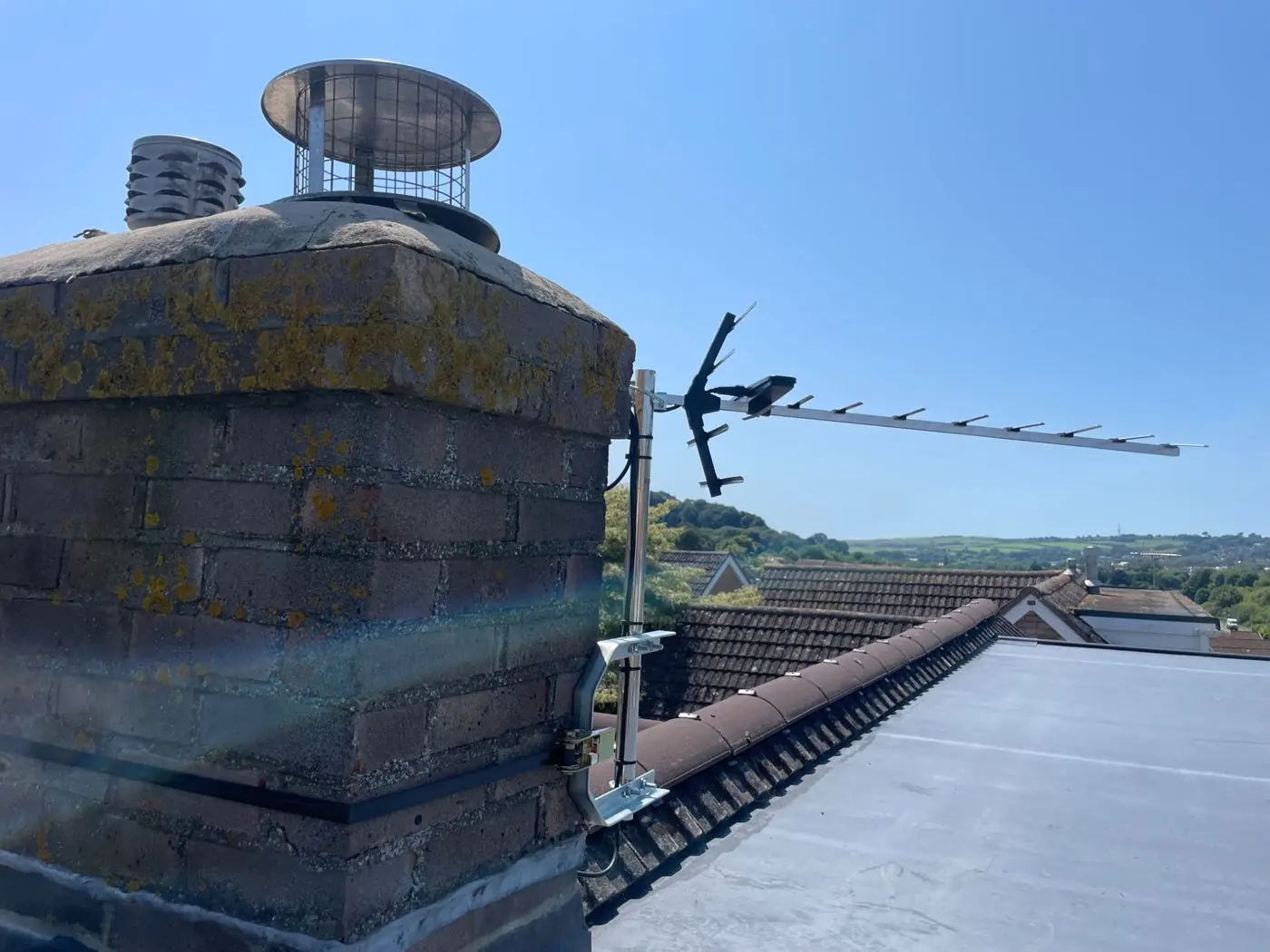 TV aerial installation mounted beside a chimney